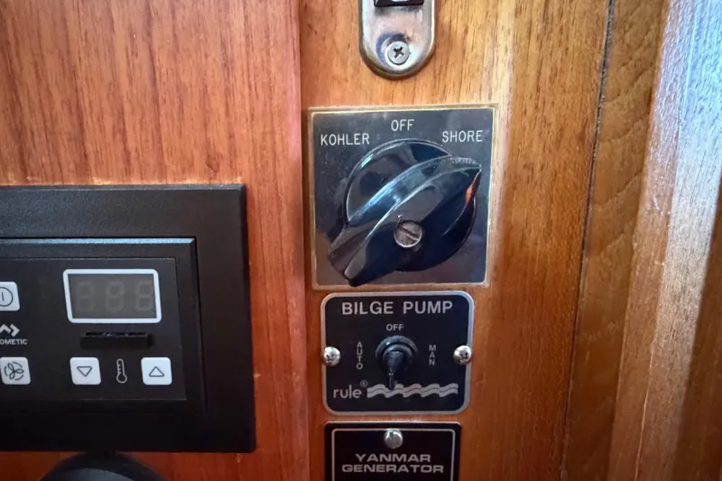 Slide: The Image of Control panel of a 1985 Albin 36 Trawler with bilge pump and generator switches. - 44