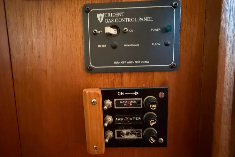 Slide: The Image of Control panel on 1985 Albin 36 Trawler, featuring gas and electrical switches. - 45