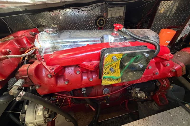 Slide: The Image of Engine of 1985 Albin 36 Trawler with red components and metallic details. - 48