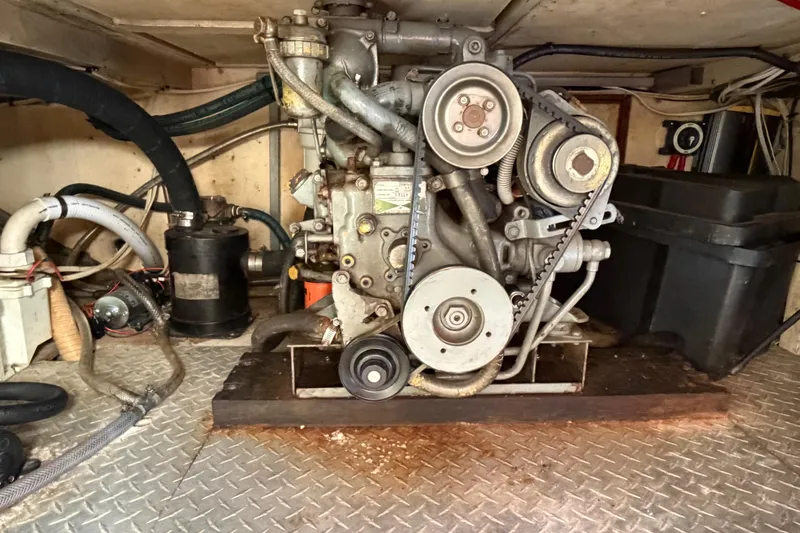 Slide: The Image of Engine compartment of a 1985 Albin 36 Trawler, showcasing mechanical components and hoses. - 50