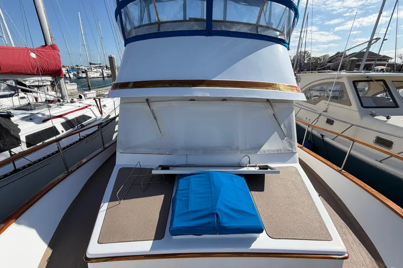 Slide: The Image of 1985 Albin 36 Trawler deck with blue cushion, docked at marina. - 6