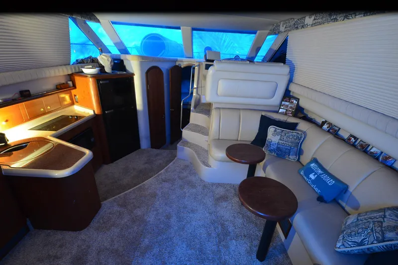 Slide: The Image of Luxurious interior of 1999 Cruisers Yachts 3585 Flybridge with cozy seating and kitchenette. - 13