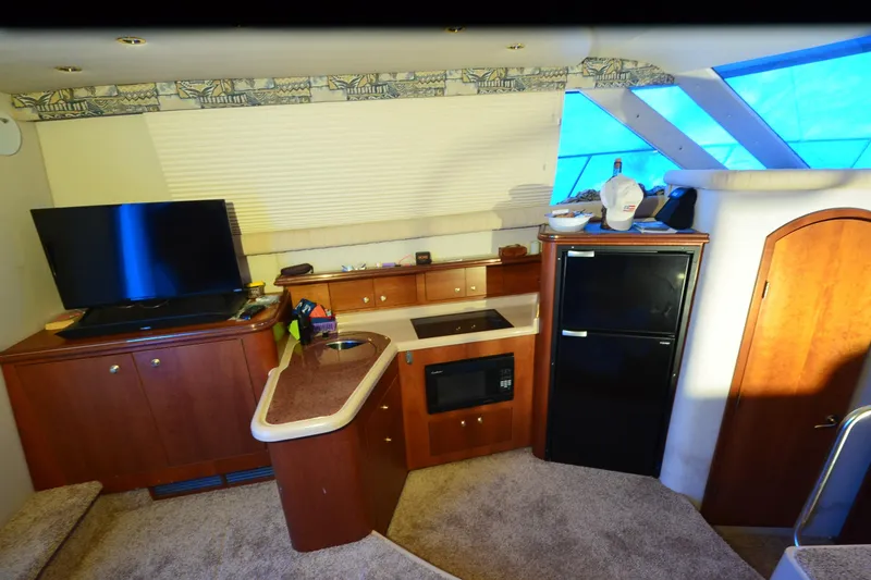 Slide: The Image of Luxurious interior of 1999 Cruisers Yachts 3585 Flybridge with kitchen and entertainment area. - 15