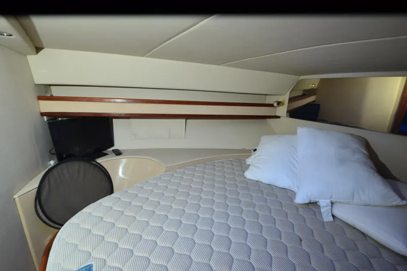 Slide: The Image of 1999 Cruisers Yachts 3585 Flybridge helm with steering wheel and control panel, illuminated in blue. - 20
