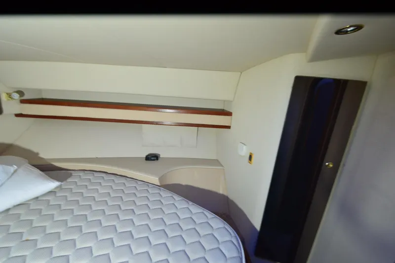 Slide: The Image of 1999 Cruisers Yachts 3585 Flybridge interior seating under blue lighting. - 21