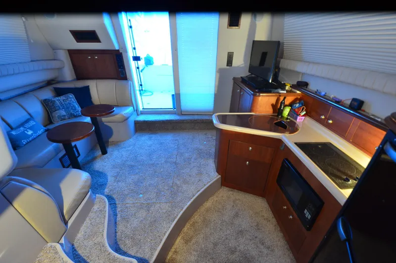 Slide: The Image of Luxurious interior of 1999 Cruisers Yachts 3585 Flybridge with modern amenities and cozy seating. - 25