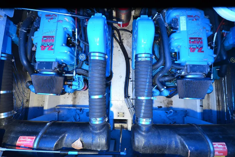 Slide: The Image of Engine room of 1999 Cruisers Yachts 3585 Flybridge with twin blue engines. - 26