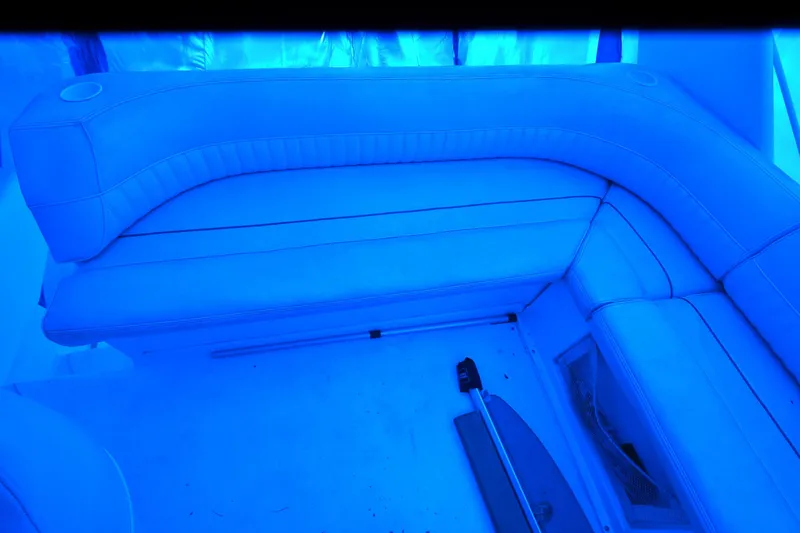 Slide: The Image of Blue-lit interior seating on a 1999 Cruisers Yachts 3585 Flybridge. - 31