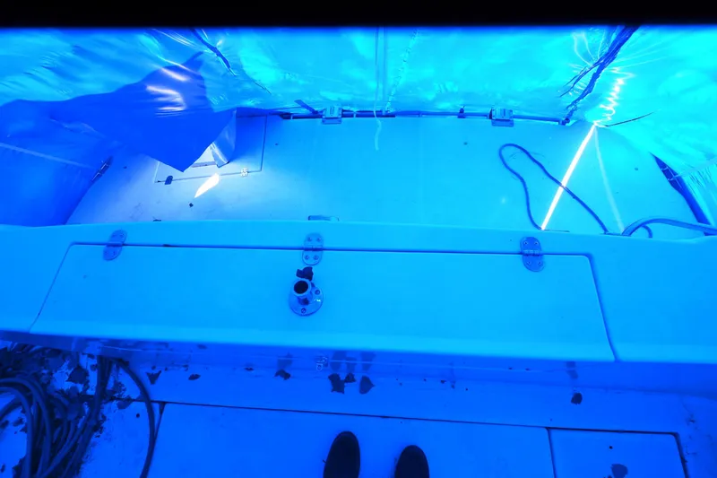 Slide: The Image of 1999 Cruisers Yachts 3585 Flybridge deck under blue tarp with ropes and fittings. - 33