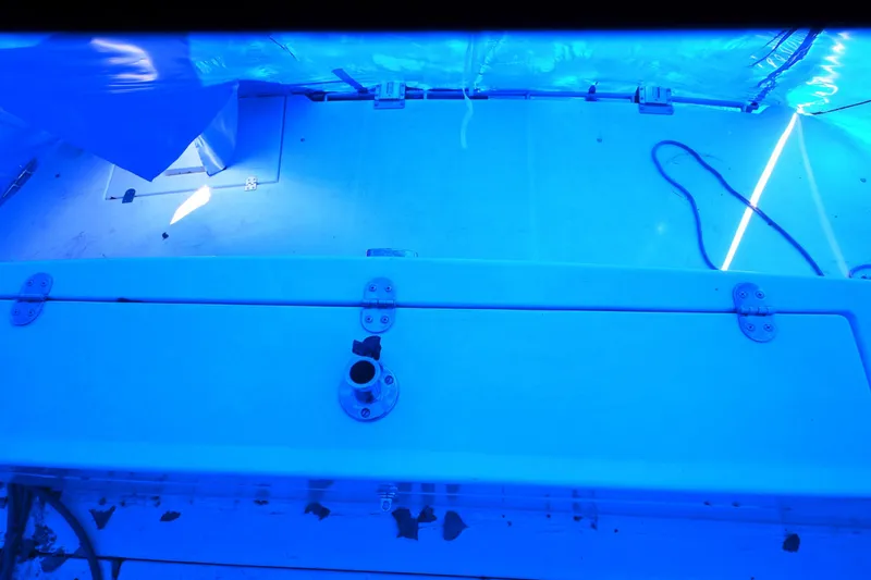 Slide: The Image of 1999 Cruisers Yachts 3585 Flybridge deck under blue tarp with visible hardware. - 34