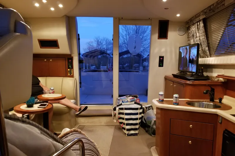 Slide: The Image of Interior of 1999 Cruisers Yachts 3585 Flybridge with seating, TV, and kitchenette. - 35