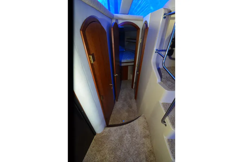 Slide: The Image of Interior hallway of 1999 Cruisers Yachts 3585 Flybridge with carpet and wooden doors. - 8