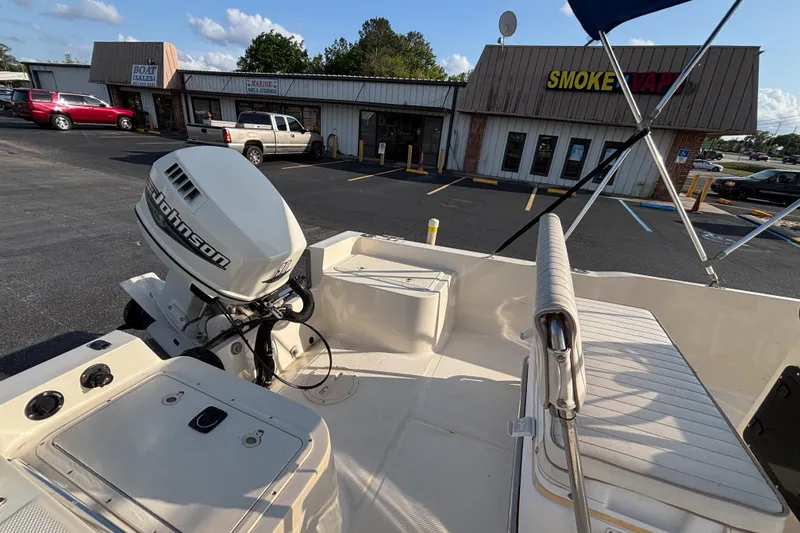 Slide: The Image of Key West 1720 Center Console boat with Johnson outboard motor in parking lot. - 15