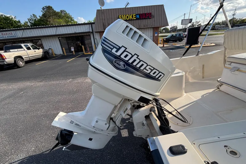 Slide: The Image of 2000 Key West 1720 Center Console with Johnson outboard motor in parking lot. - 16
