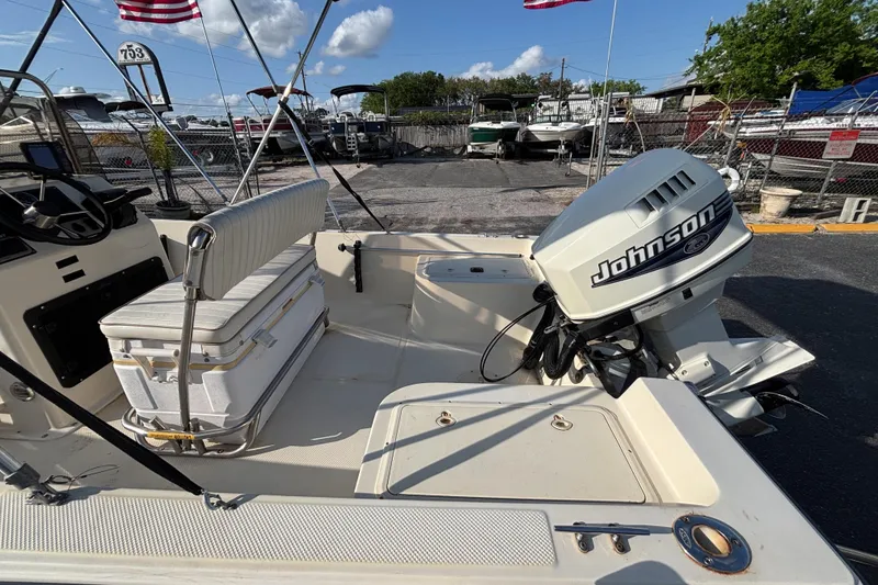 Slide: The Image of 2000 Key West 1720 Center Console boat with Johnson outboard motor in a marina setting. - 19