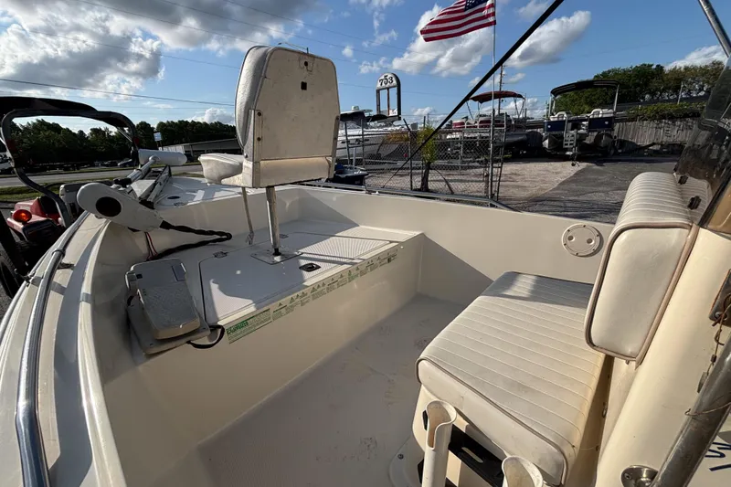 Slide: The Image of 2000 Key West 1720 Center Console boat interior with seating and American flag in background. - 24