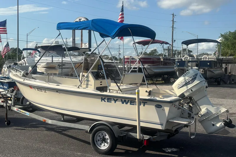 Slide: The Image of 2000 Key West 1720 Center Console boat with Johnson outboard motor on trailer. - 4