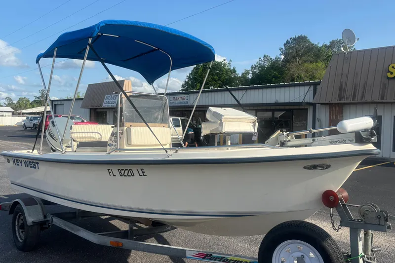 Slide: The Image of 2000 Key West 1720 Center Console boat with blue canopy on trailer. - 8