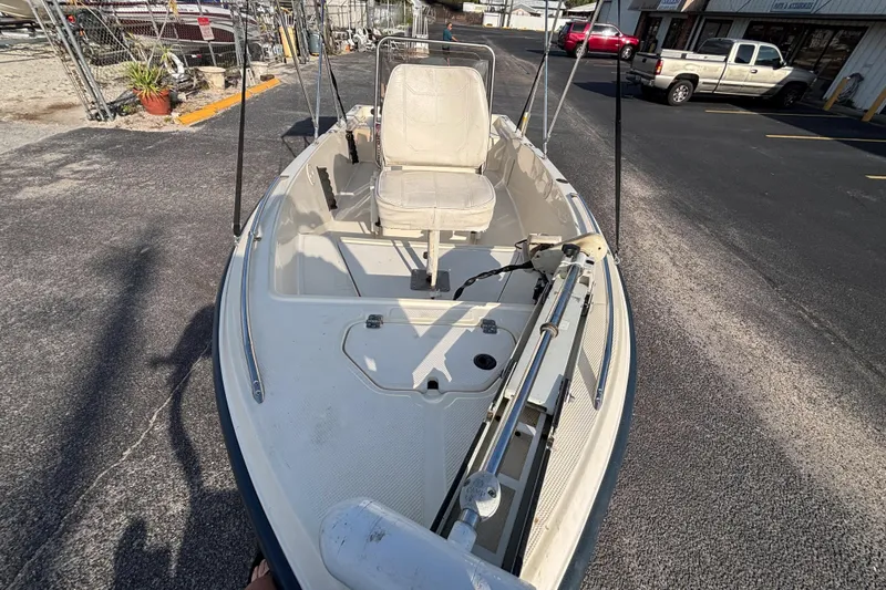 Slide: The Image of 2000 Key West 1720 Center Console boat parked on asphalt, featuring a single seat and steering console. - 9