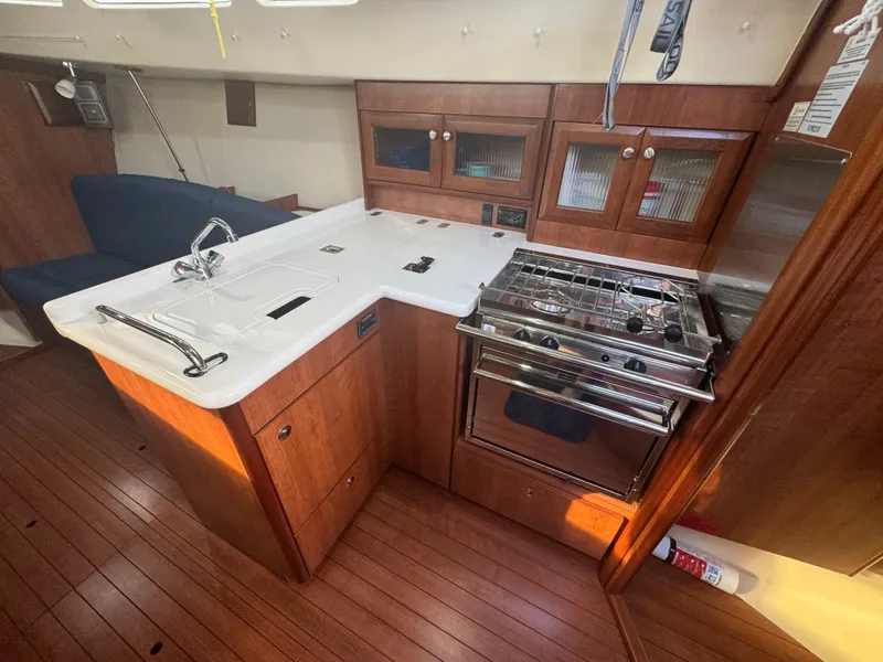 Slide: The Image of 2017 Marlow-Hunter 31 yacht interior kitchen with stove and sink. - 10