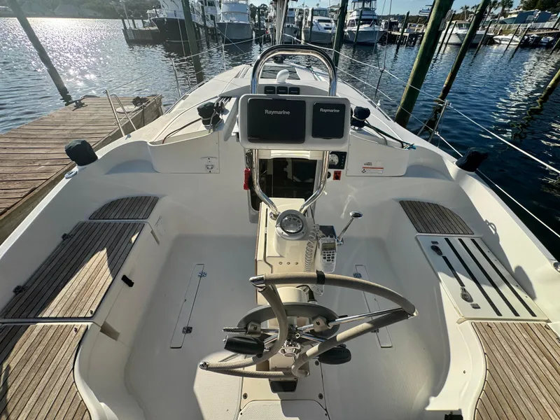 Slide: The Image of 2017 Marlow-Hunter 31 sailboat cockpit with dual displays, docked at marina. - 14