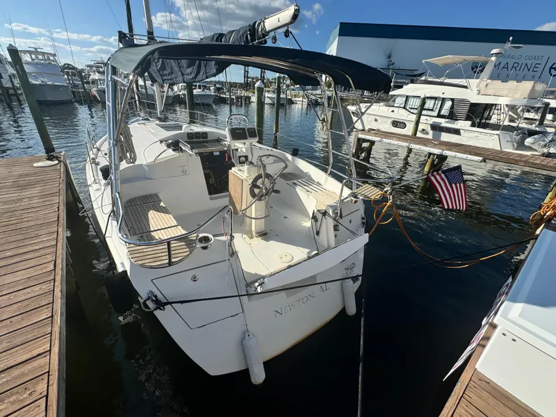 Slide: The Image of 2017 Marlow-Hunter 31 sailboat docked at marina, sunny day, American flag displayed. - 3