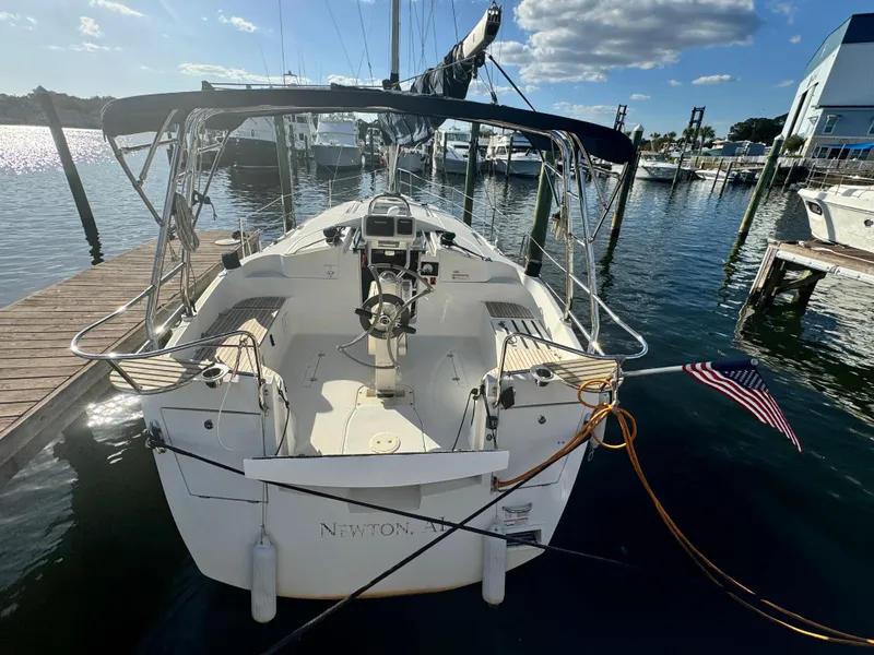 Slide: The Image of 2017 Marlow-Hunter 31 sailboat docked at marina with American flag. - 4
