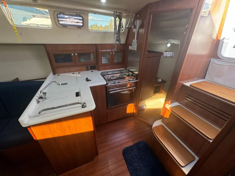 Slide: The Image of Interior of 2017 Marlow-Hunter 31 sailboat with modern kitchen and wooden flooring. - 7