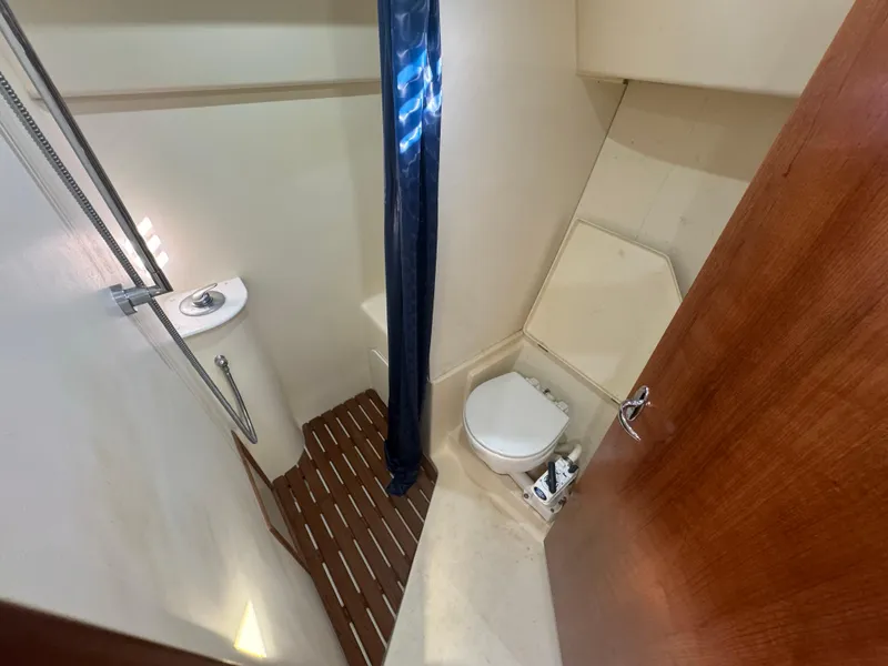 Slide: The Image of 2017 Marlow-Hunter 31 yacht bathroom with shower, toilet, and wooden flooring. - 8