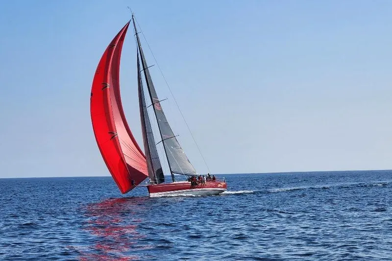 The Image of Red Laurie Davidson TP-52 sailboat from 1999 gliding on open sea with vibrant sails. - 0