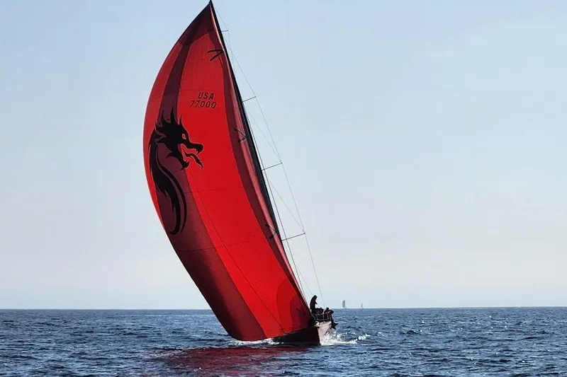 Slide: The Image of Red sailboat on open sea, Laurie Davidson TP-52, 1999 model, with dragon design. - 1