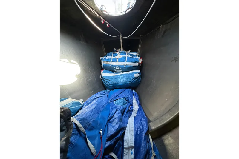 Slide: The Image of Interior of 1999 Laurie Davidson TP-52 sailboat with blue sails stored. - 10