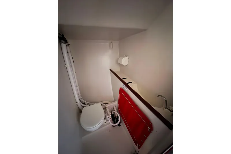 Slide: The Image of Compact bathroom in 1999 Laurie Davidson TP-52 yacht, featuring toilet and sink. - 9