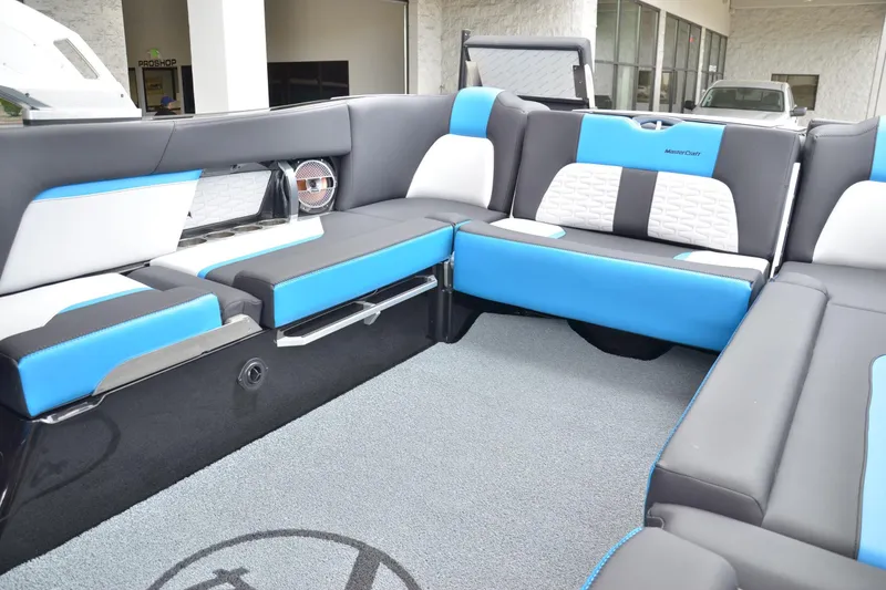 Slide: The Image of 2020 MasterCraft X24 boat interior with blue and white seating, modern design. - 10