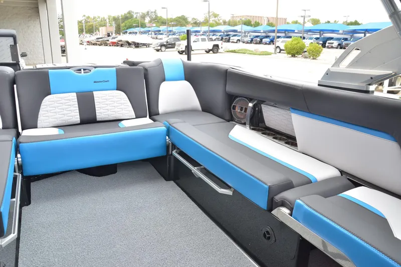 Slide: The Image of 2020 MasterCraft X24 boat interior with blue and gray seating, showcasing modern design. - 11