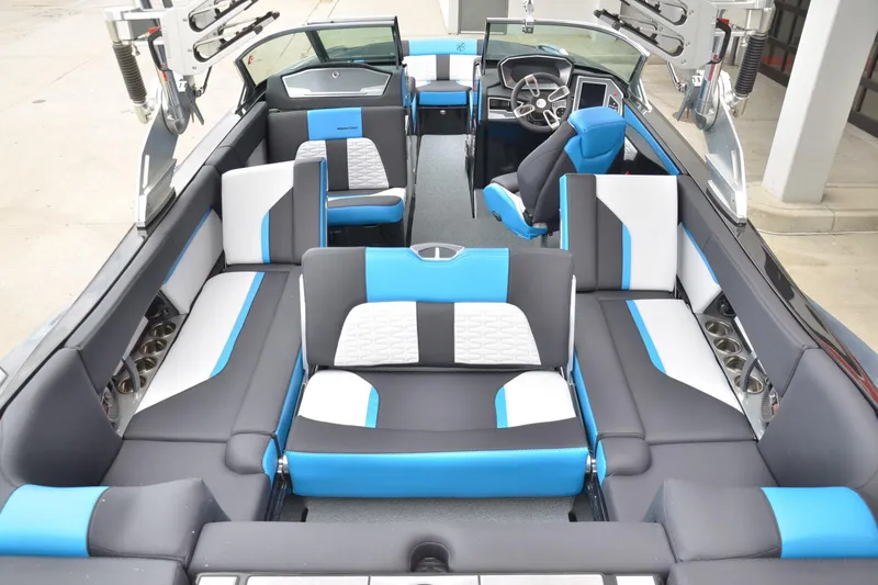 Slide: The Image of 2020 MasterCraft X24 boat interior with modern blue and white seating design. - 13