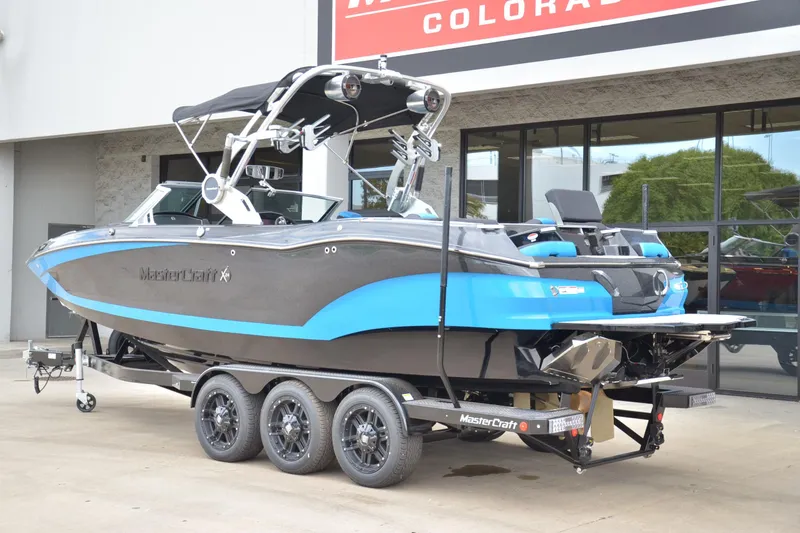 Slide: The Image of 2020 MasterCraft X24 boat on trailer, displayed outside dealership. - 3