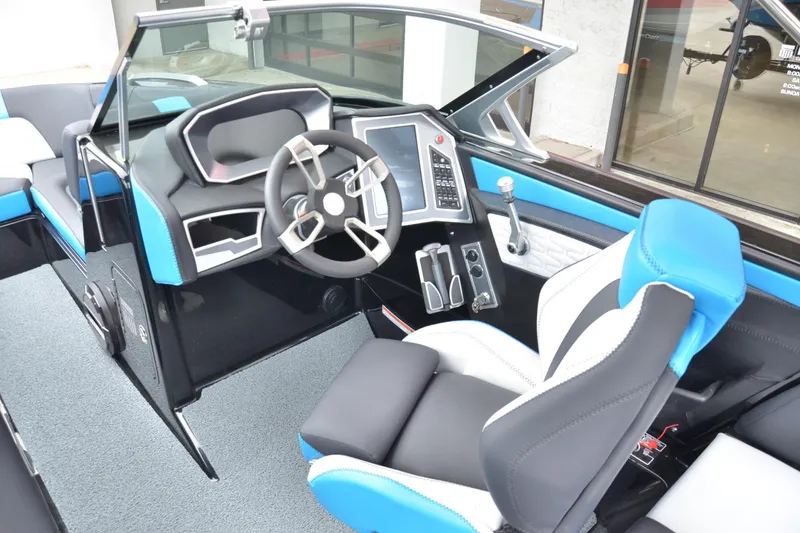 Slide: The Image of 2020 MasterCraft X24 boat interior with modern steering and blue-accented seating. - 8