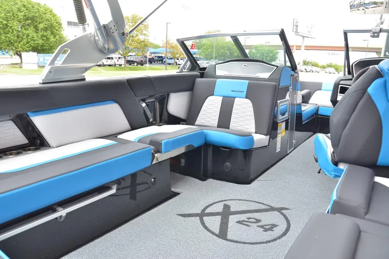 Slide: The Image of 2020 MasterCraft X24 boat interior with blue and white seating, modern design. - 9