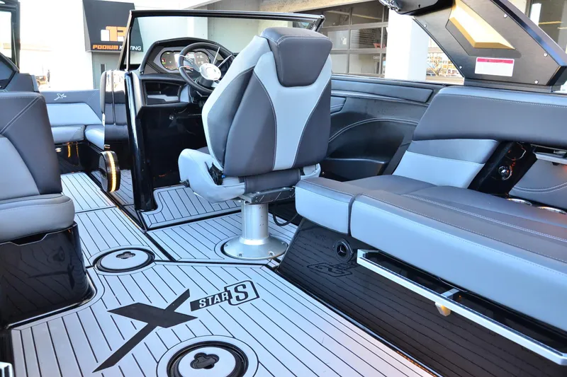 Slide: The Image of 2024 MasterCraft XStar S boat interior with sleek seating and modern dashboard design. - 13