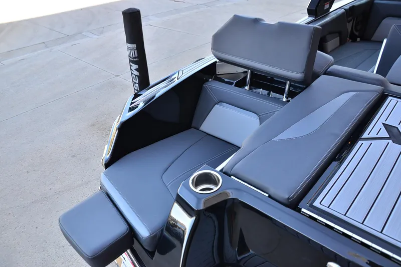 Slide: The Image of 2024 MasterCraft XStar S boat interior with sleek gray seating and cup holder. - 17