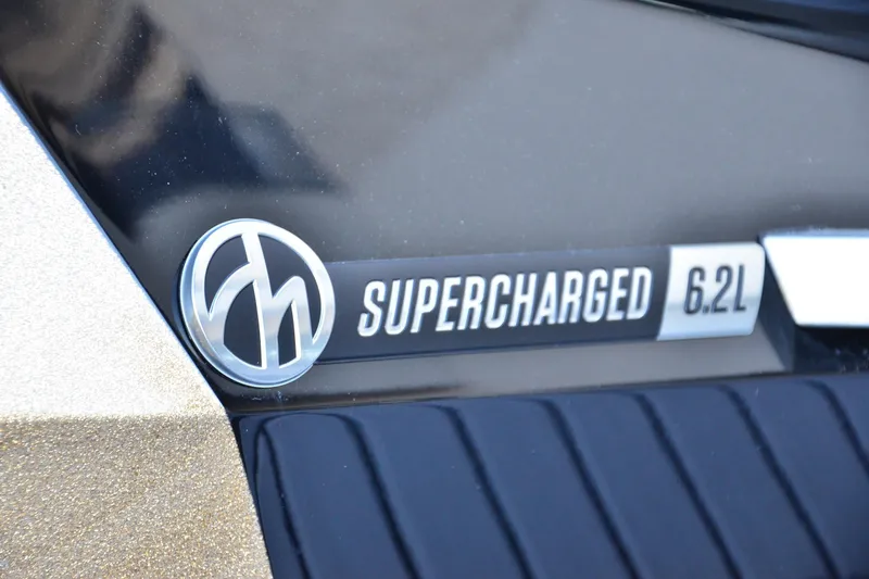 Slide: The Image of 2024 MasterCraft XStar S supercharged 6.2L engine badge close-up. - 23