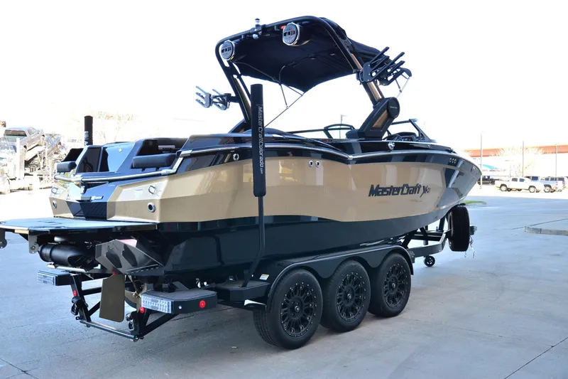 Slide: The Image of 2024 MasterCraft XStar S boat on trailer, showcasing sleek design and modern features. - 3