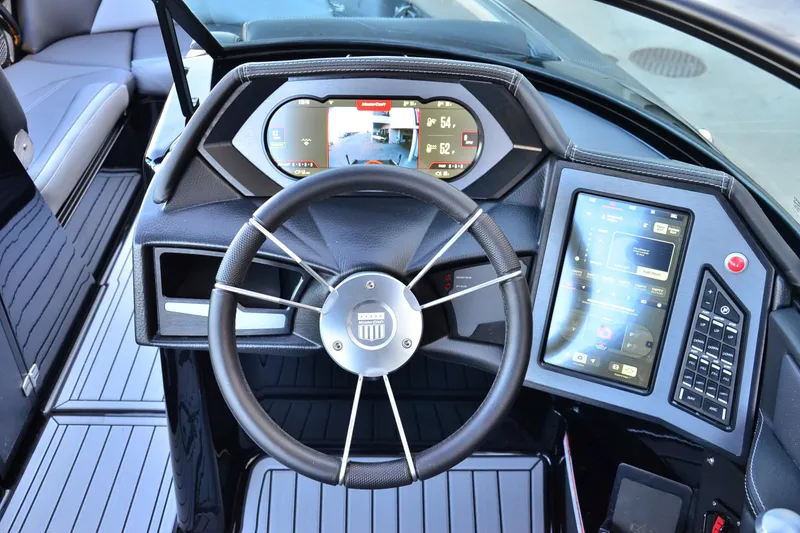Slide: The Image of 2024 MasterCraft XStar S dashboard with modern steering wheel and digital controls. - 9