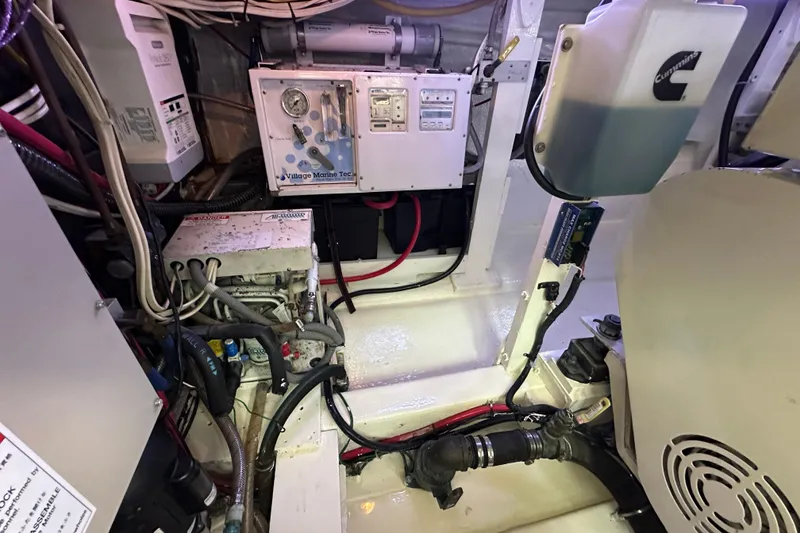 Slide: The Image of Engine room of a 1976 Pacifica Flybridge boat with various mechanical components. - 12
