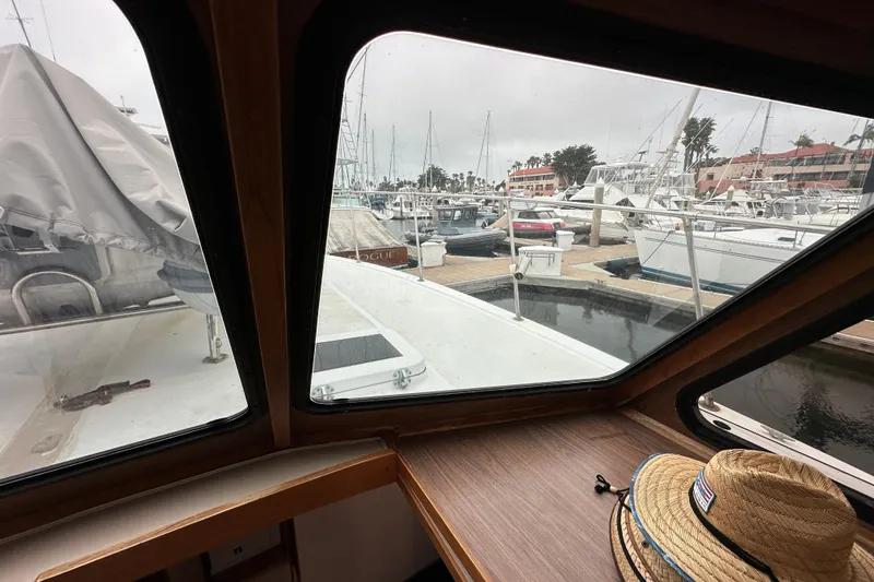 Slide: The Image of View from 1976 Pacifica Flybridge boat cabin overlooking marina with docked boats. - 22