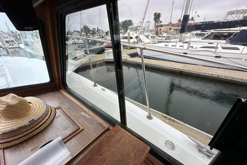 Slide: The Image of View from 1976 Pacifica Flybridge boat window overlooking marina with docked yachts. - 23