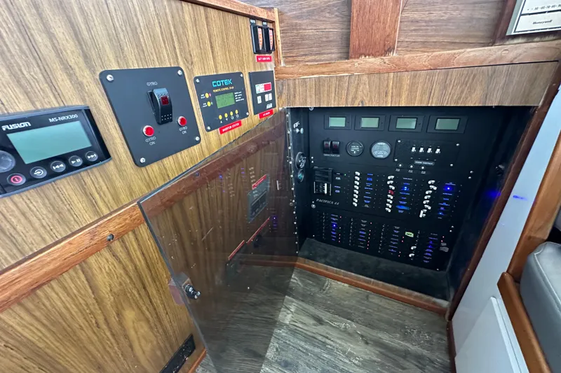 Slide: The Image of Control panel of a 1976 Pacifica Flybridge boat with various switches and gauges. - 24