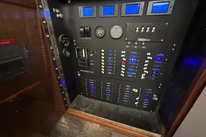 Slide: The Image of Electrical control panel of a 1976 Pacifica Flybridge boat, featuring various switches and gauges. - 25