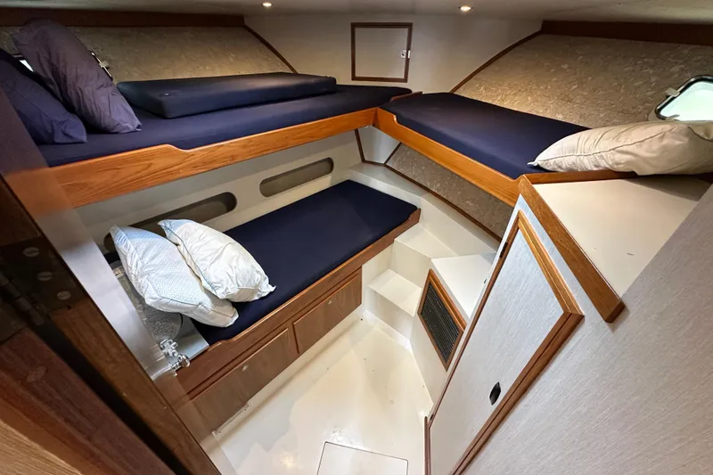 Slide: The Image of Cozy cabin interior of a 1976 Pacifica Flybridge boat with bunk beds and pillows. - 28